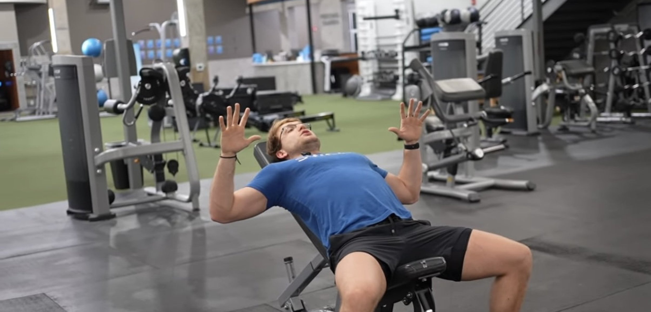 Person performing a bench press in the gym