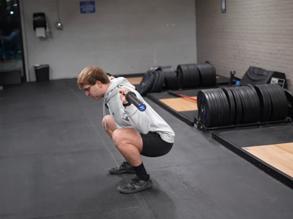 Person performing a deep squat in the gym