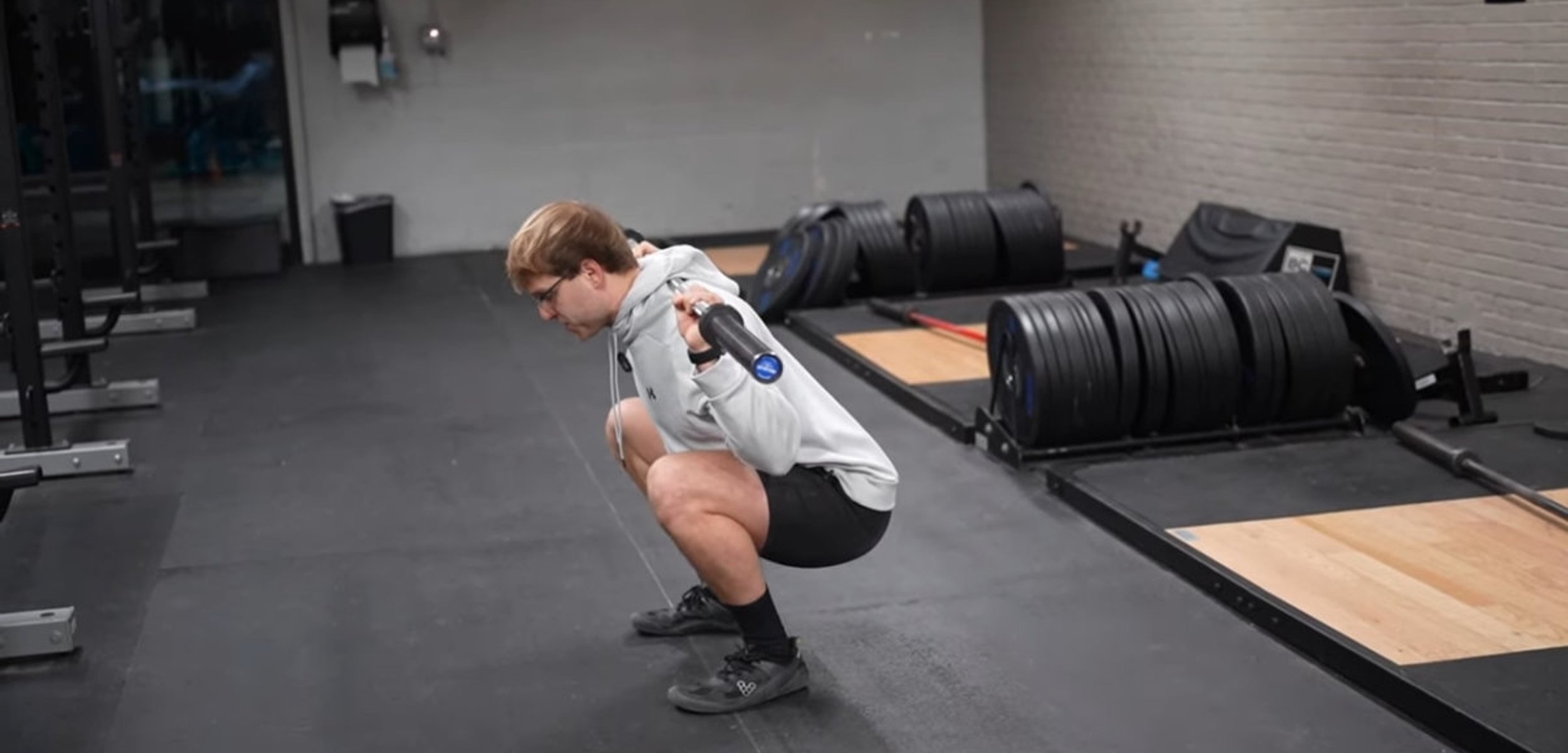 Person performing a deep squat in the gym