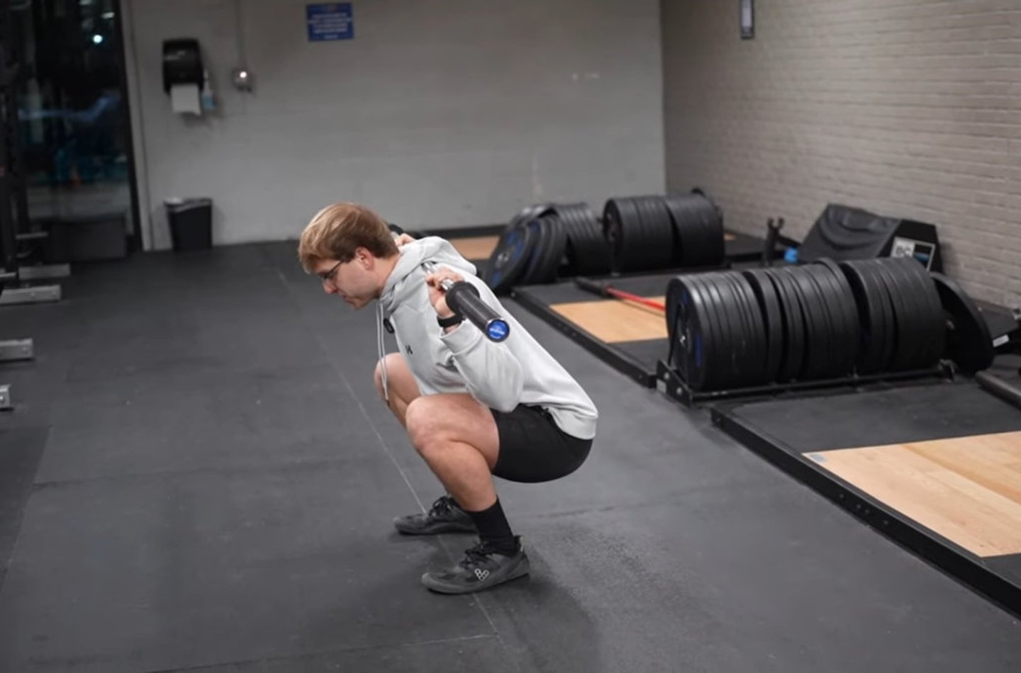 Person performing a deep squat in the gym