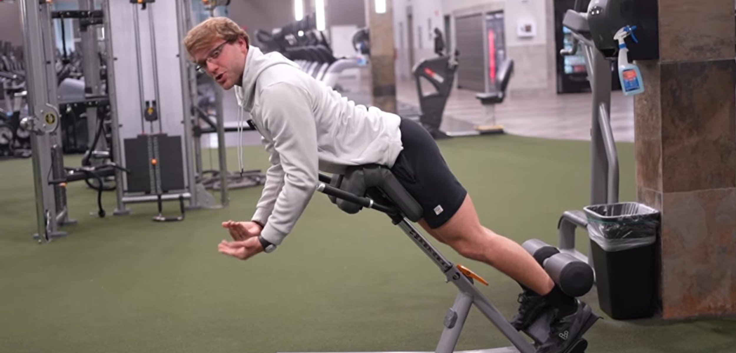 Person holding their lower back in discomfort