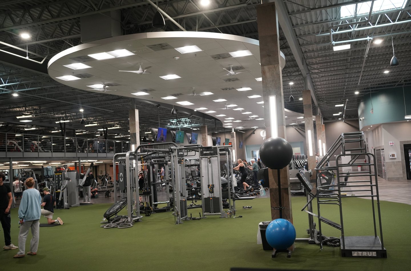Personal trainer talking with a client on the gym floor