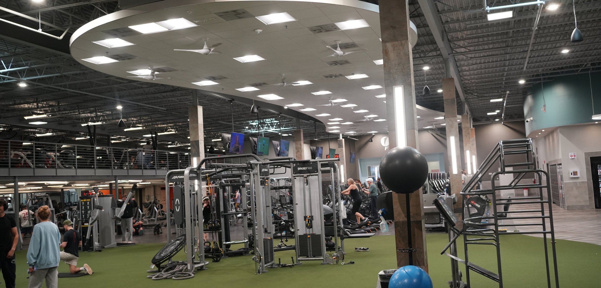 Personal trainer talking with a client on the gym floor