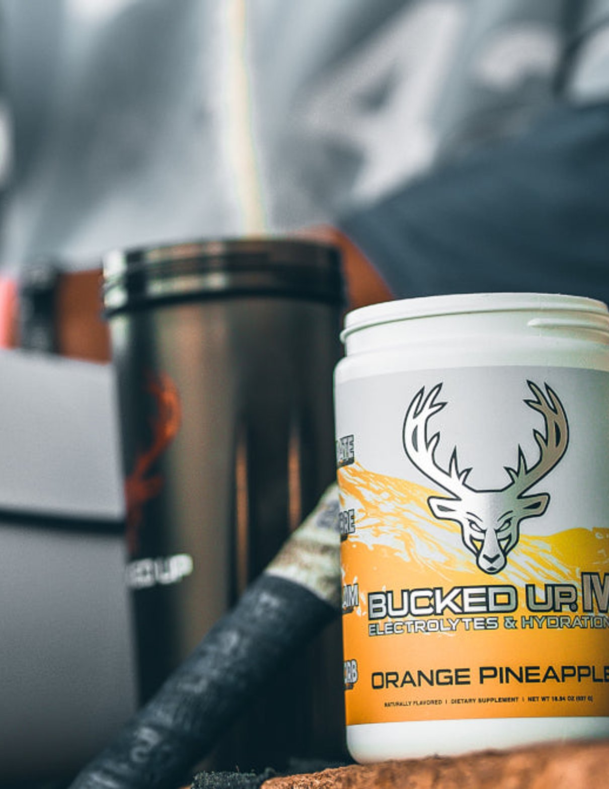 Bucked Up preworkout in front of a shaker cup